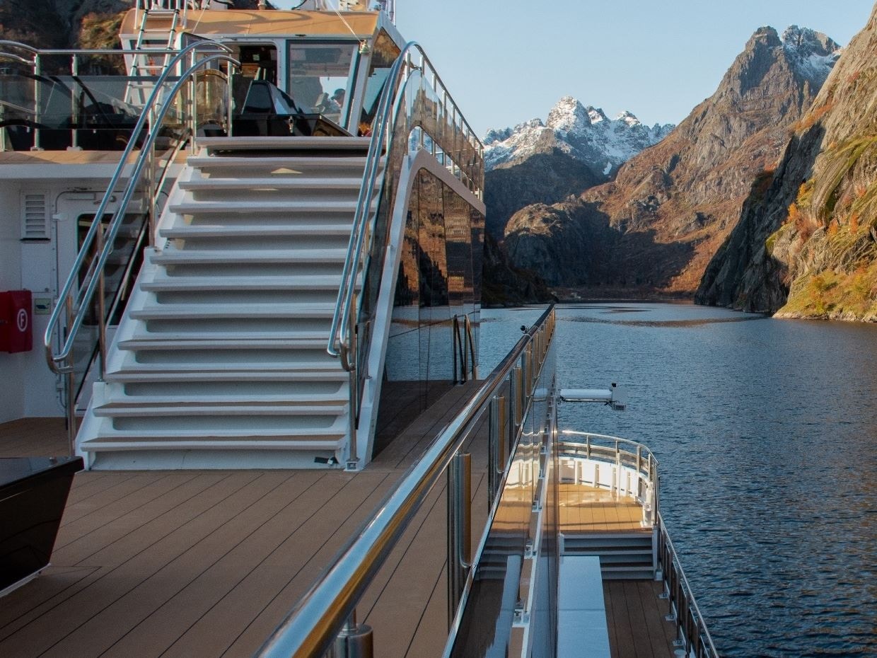 Cruise ship deck with stairs, surrounded by Lofoten mountains during Silent Trollfjord Cruise.