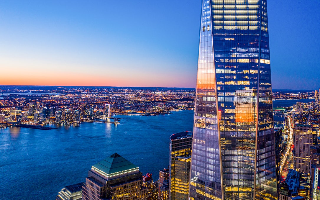 One World Observatory view at sunset over New York City skyline and Hudson River.