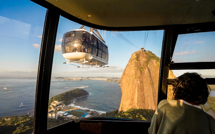 Cable car approaching Sugar Loaf Mountain at sunset, Rio de Janeiro.