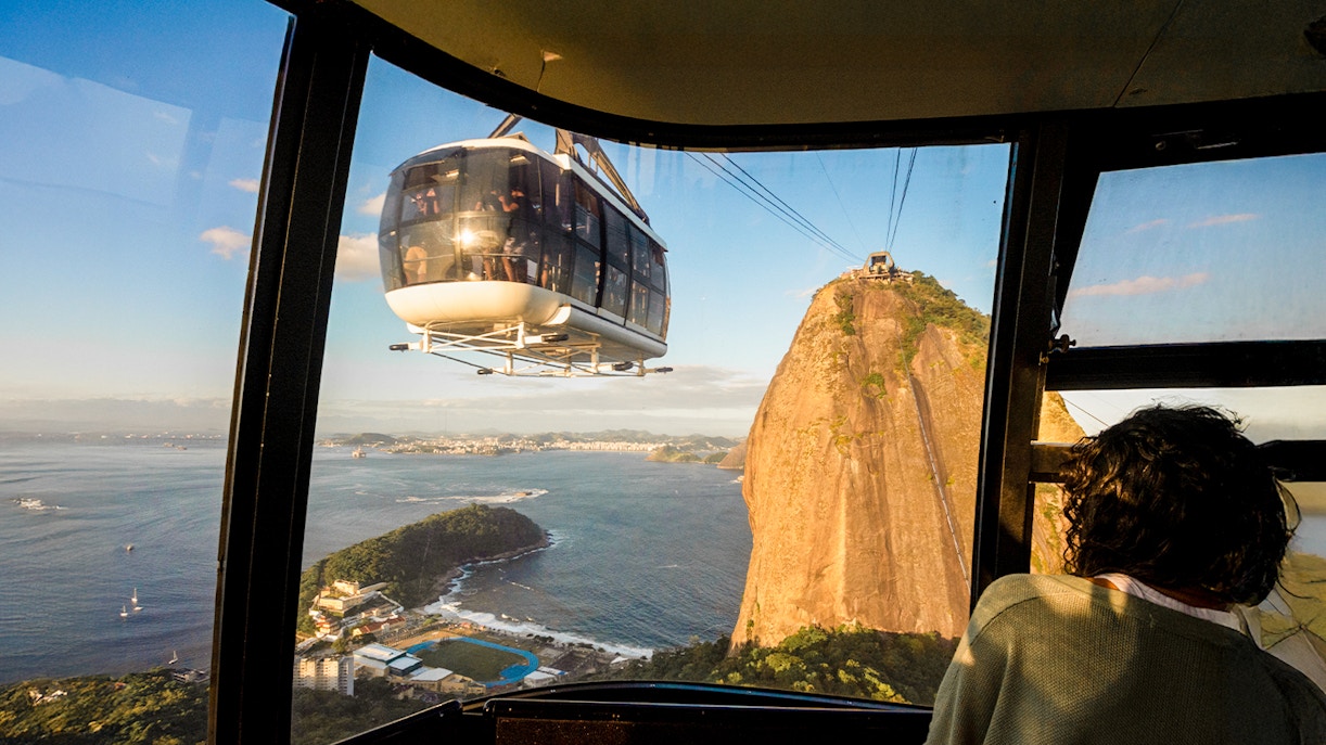 Cable car approaching Sugar Loaf Mountain at sunset, Rio de Janeiro.