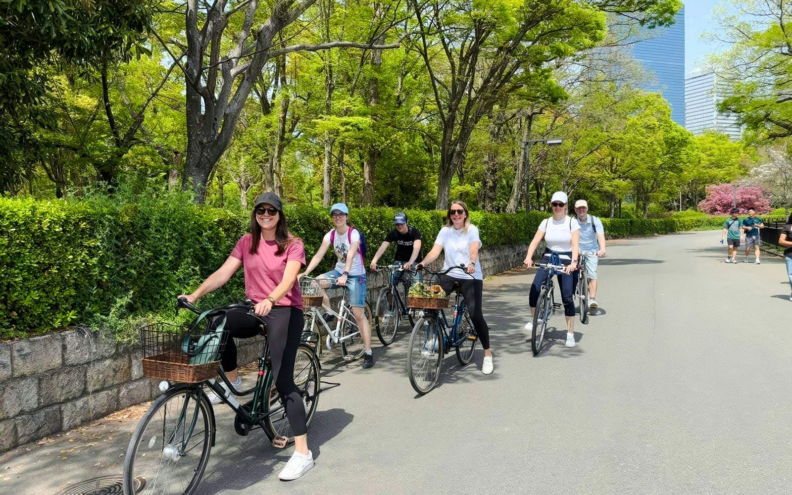 Friends biking near Osaka Castle on a guided tour.
