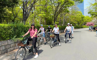 Friends biking near Osaka Castle on a guided tour.