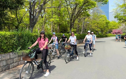Friends biking near Osaka Castle on a guided tour.
