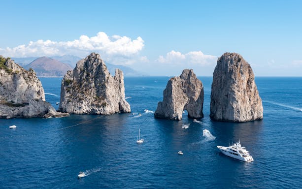 Boats in Marina Grande with colorful buildings on the Island of Capri, Italy.