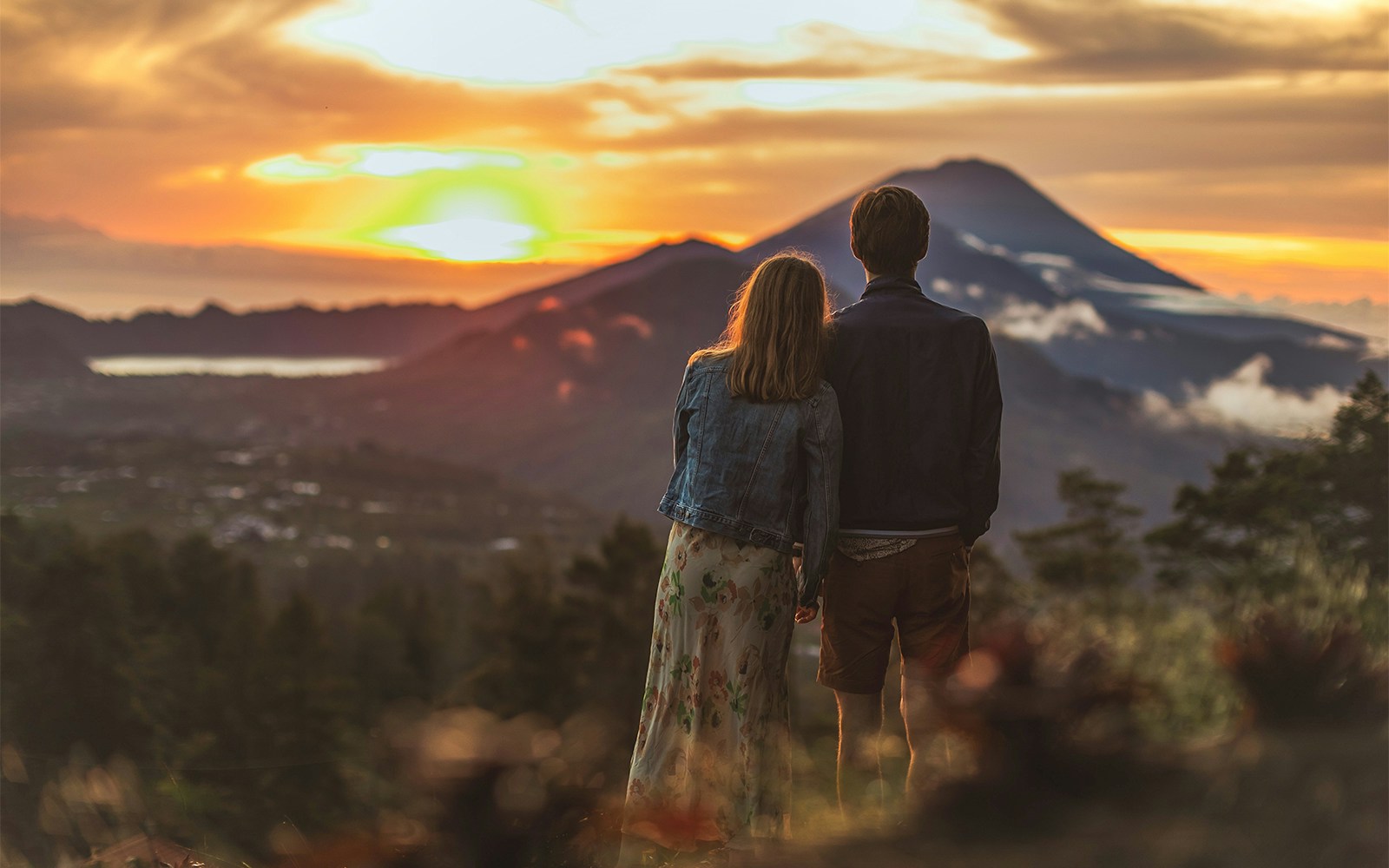 A couple watching the sunrise from Mt. Batur