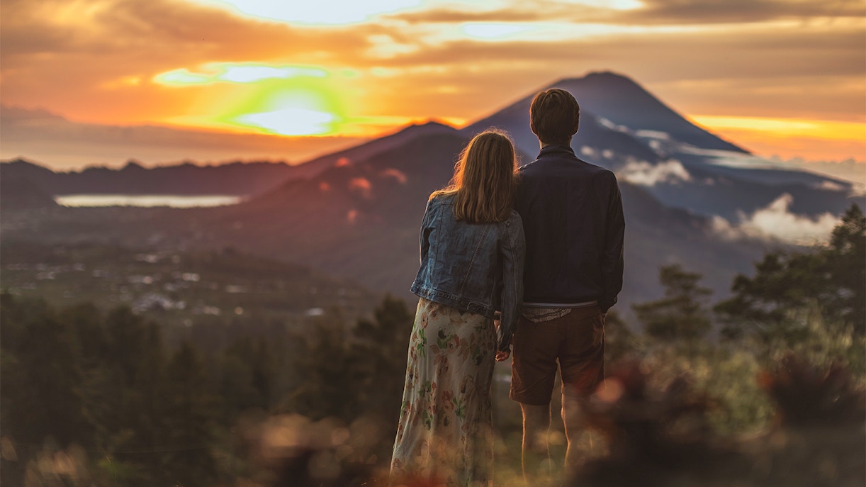 A couple looking at the sunset from Mount Batur