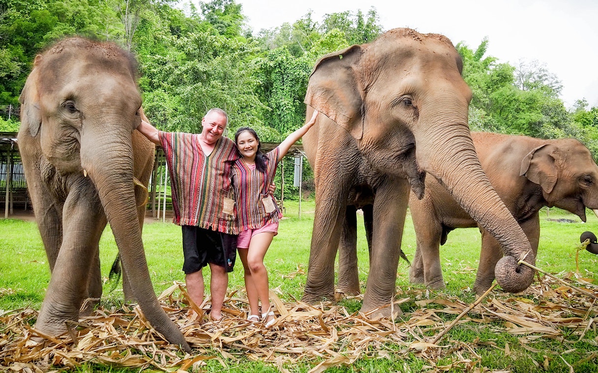 Tourists with elephants at Elephant Jungle Sanctuary, Chiang Mai.