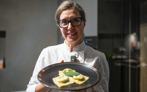 Chef presenting homemade ravioli during a cooking class in Rome.
