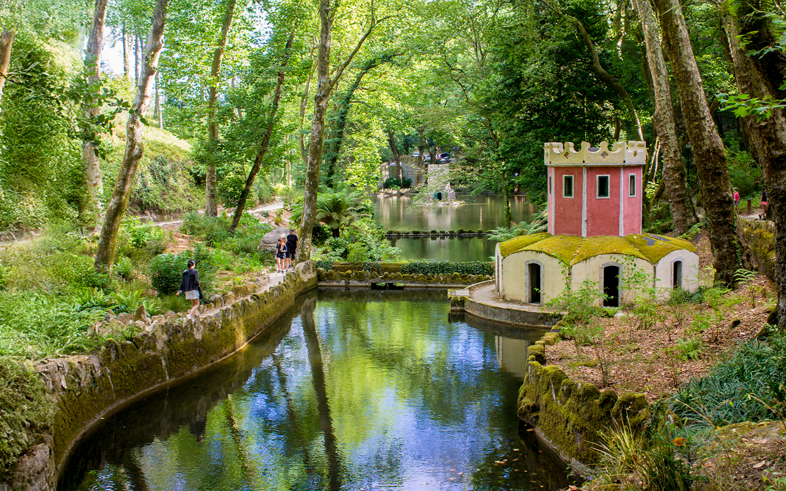 Pond and small tower in the gardens of Pena Palace, Sintra, Portugal.