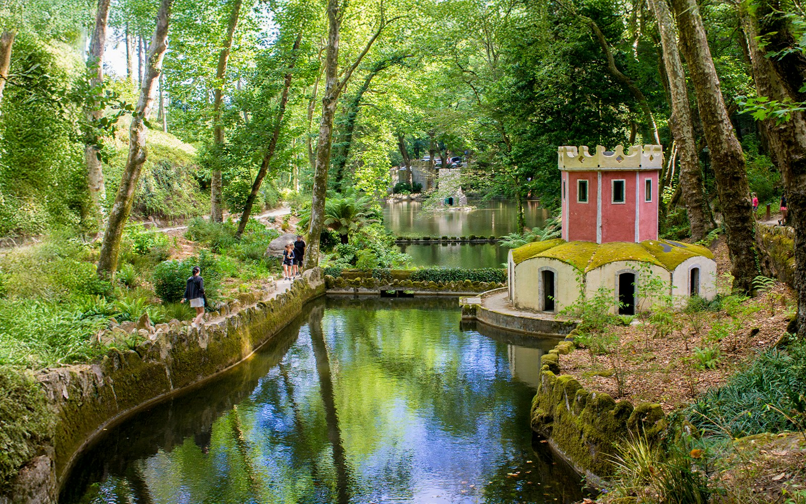 Pond and small tower in the gardens of Pena Palace, Sintra, Portugal.