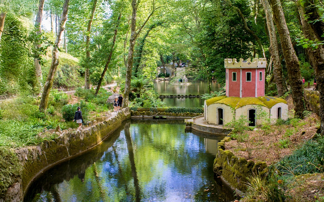 Pond and small tower in the gardens of Pena Palace, Sintra, Portugal.
