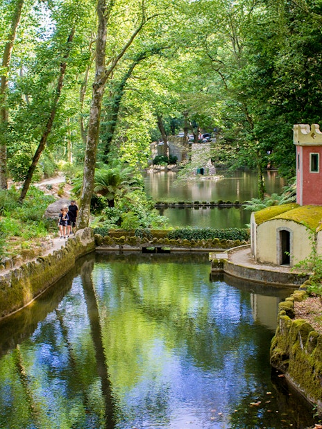 Pond and small tower in the gardens of Pena Palace, Sintra, Portugal.