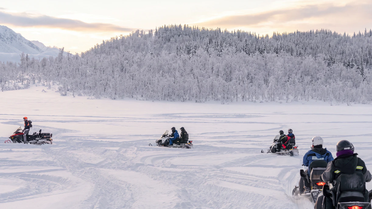 Snowmobile riders in snowy Lyngen Alps, Tromsø.