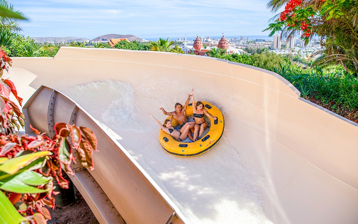Giant tire ride at Siam Park, Tenerife with people enjoying the water slide.