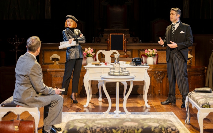 Cast members of "Witness for the Prosecution" in courtroom attire on West End stage.