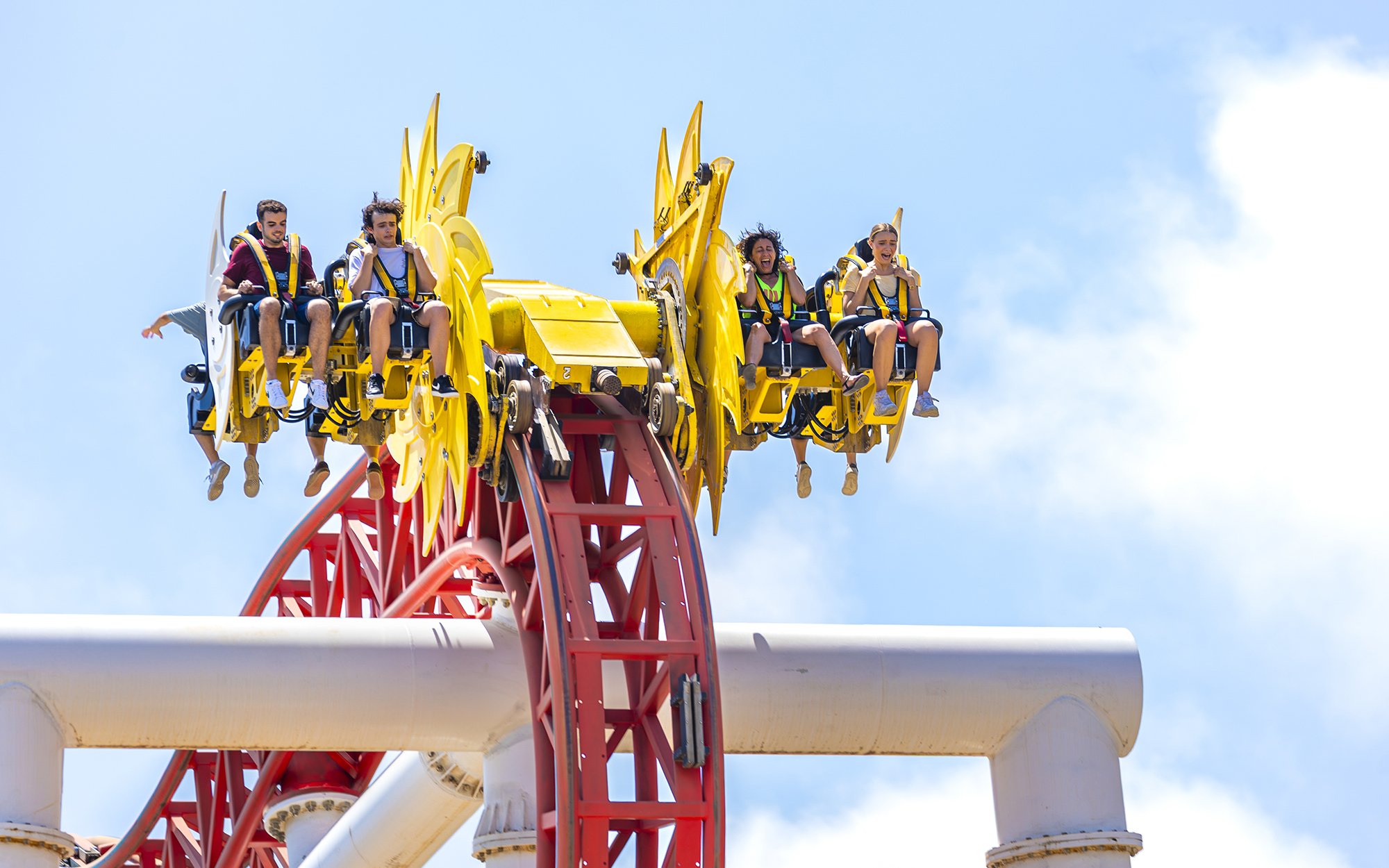 Roller coaster riders at Terra Mitica Benidorm on a loop track.