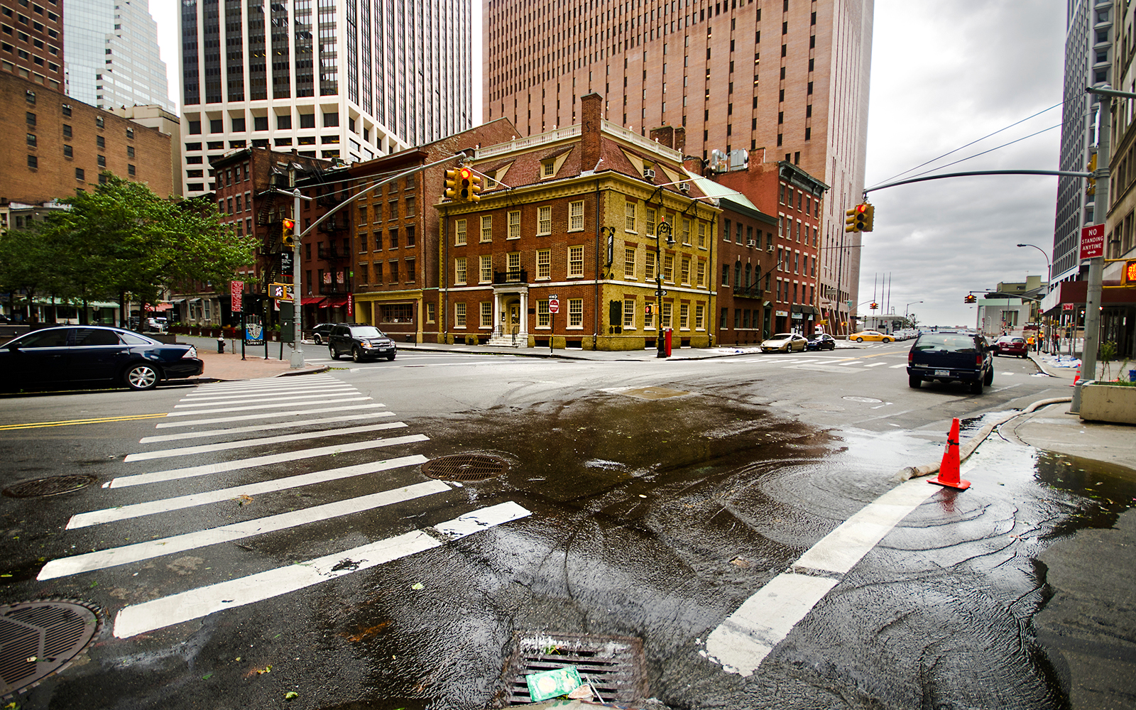 Fraunces Tavern in New York City at a street intersection with surrounding buildings.