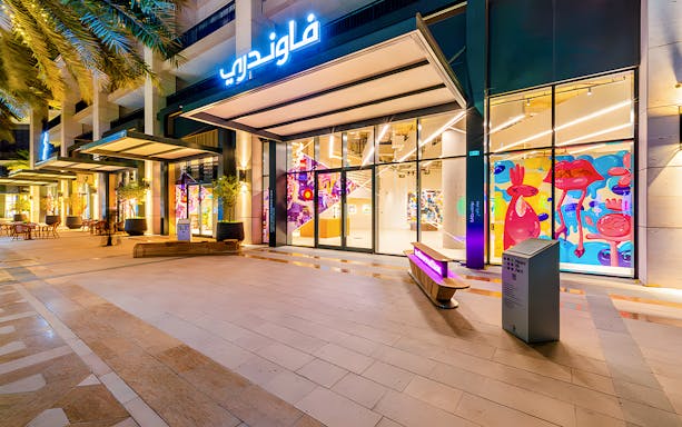 Exterior view of The Glam Factory with vibrant pop art displays, related to Andy Warhol tickets.