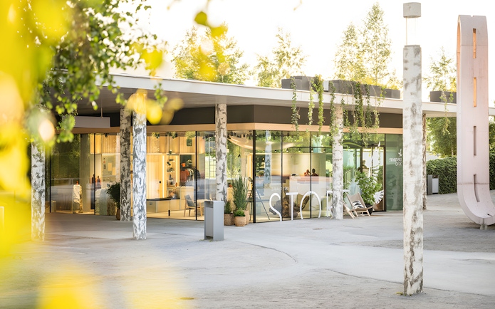 Swarovski Crystal Worlds entrance with modern glass facade and surrounding greenery.