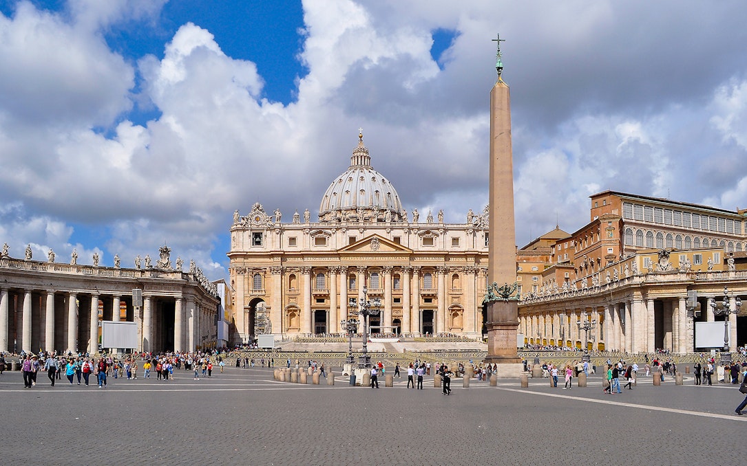 St. Peter’s Basilica and Square with obelisk, Vatican City, crowded with visitors.