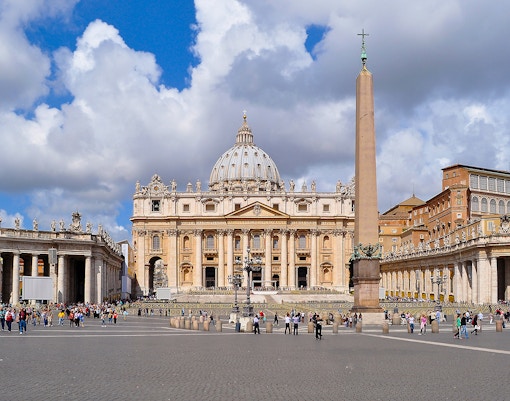 St. Peter's Basilica and Square with tourists exploring Vatican City.