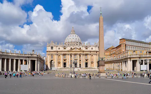 St. Peter’s Basilica and Square with obelisk, Vatican City, crowded with visitors.