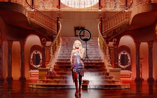 Grand staircase in opulent mansion setting, associated with The Queen of Versailles.