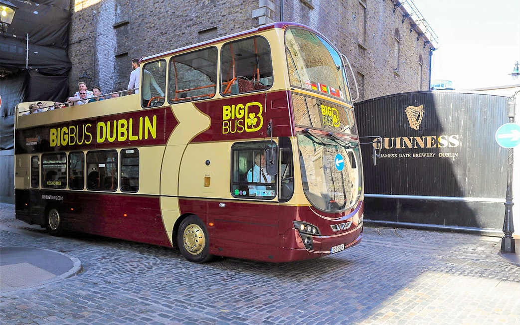 Big Bus tour passing Guinness Storehouse in Dublin.