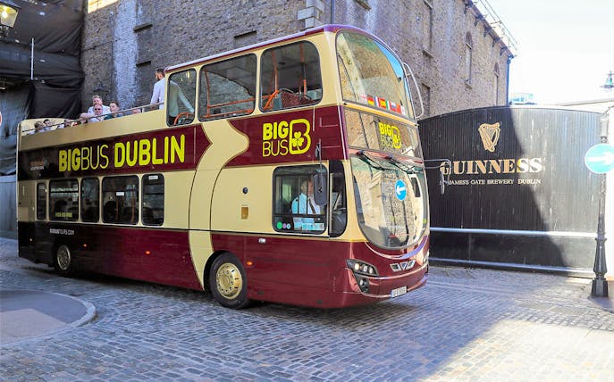Big Bus tour passing Guinness Storehouse in Dublin.