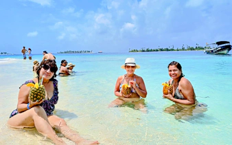 Tourists enjoying drinks in the water at Islas de San Blas, Panama.