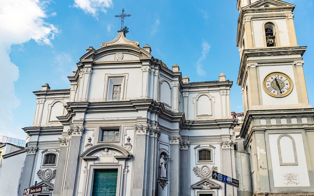 Basilica of Santa Maria della Sanita facade with clock tower in Naples, Italy.