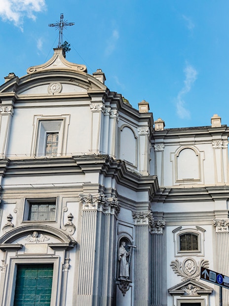 Basilica of Santa Maria della Sanita facade with clock tower in Naples, Italy.