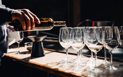 Pouring wine into glasses during Wawel Castle tour in Krakow.