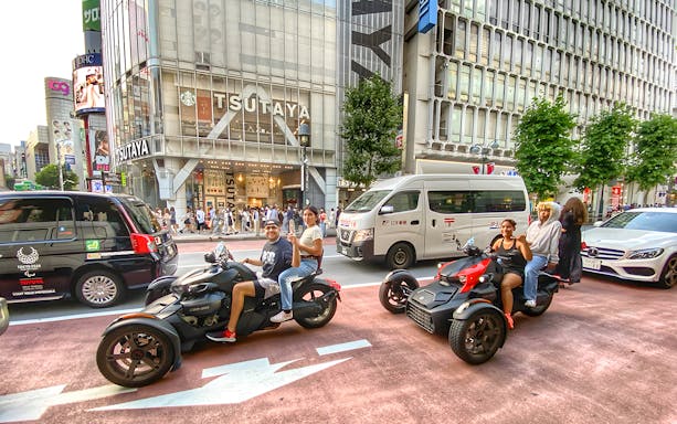 Go-kart riders in Gotanda, Tokyo, posing for a photoshoot in front of Tsutaya building.