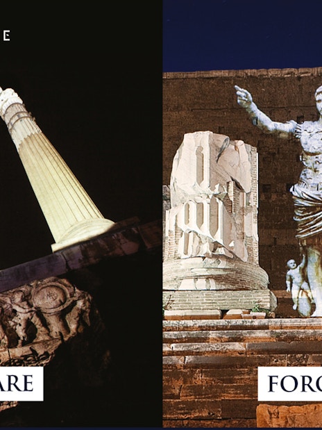 Foro di Cesare and Foro di Augusto illuminated at night in Rome.