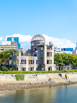 Hiroshima Peace Memorial near Orizuru Tower, Japan, with river and cityscape.