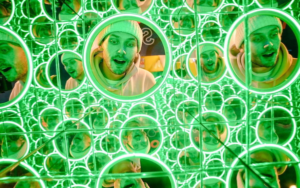 Guest exploring mirror maze at World of Illusion, Dublin.