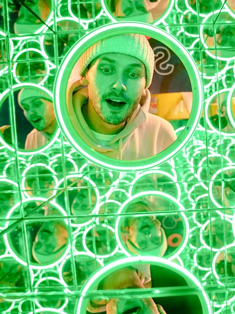 Guest exploring mirror maze at World of Illusion, Dublin.