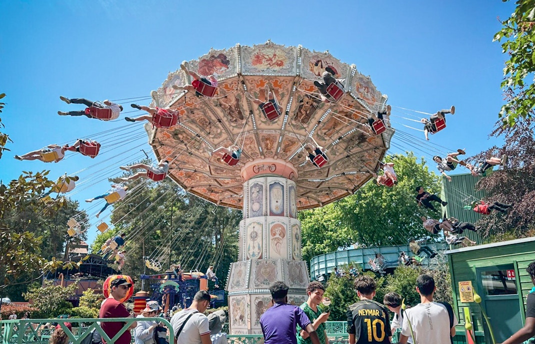 Swing ride at Parc Asterix, France with people enjoying the thrilling experience.