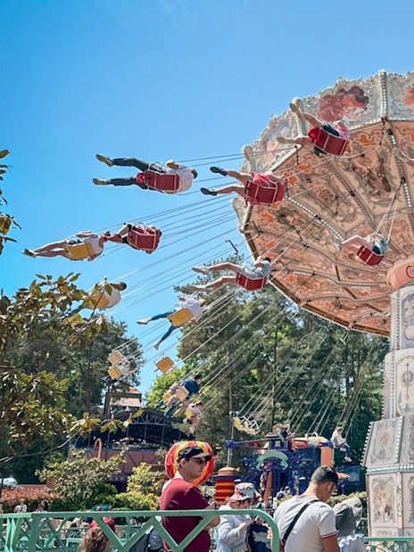 Swing ride at Parc Asterix, France with people enjoying the thrilling experience.