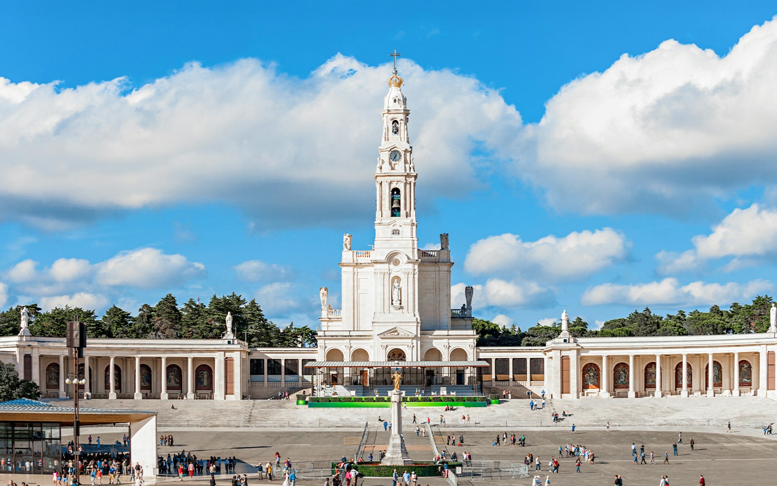 Sanctuary of Fatima with central basilica and visitors in the courtyard, Portugal.