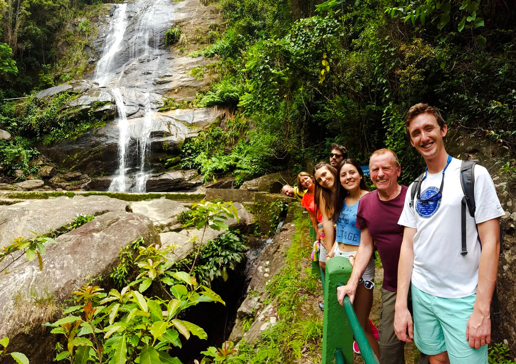 Group enjoying a waterfall in Tijuca Forest, Rio de Janeiro.
