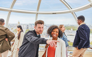 Visitors enjoying the view from the London Eye capsule.
