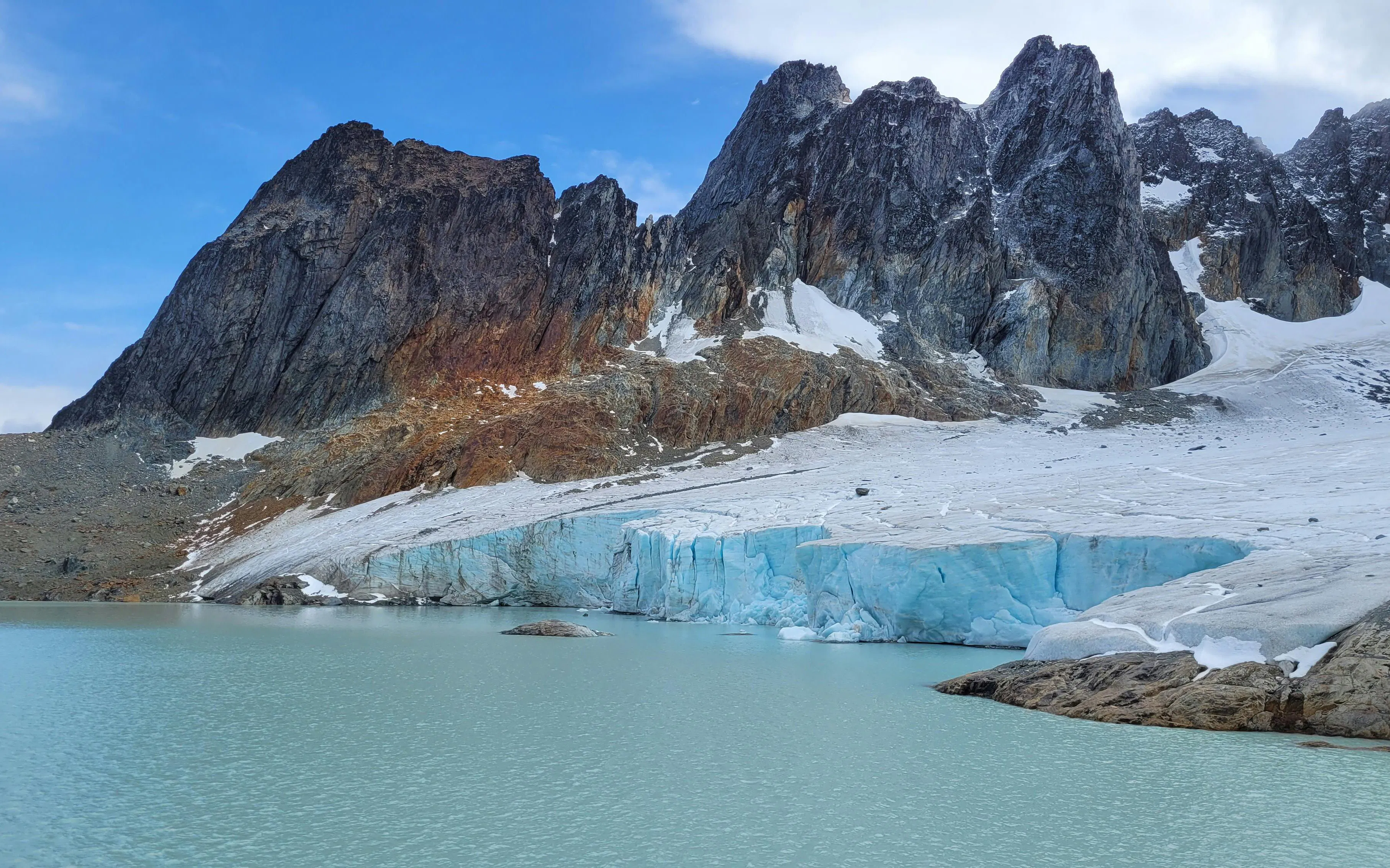Ojo del Albino Glacier with rugged mountains and icy lake in Ushuaia, Argentina.