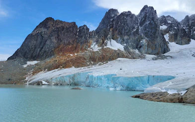 Ojo del Albino Glacier with rugged mountains and icy lake in Ushuaia, Argentina.