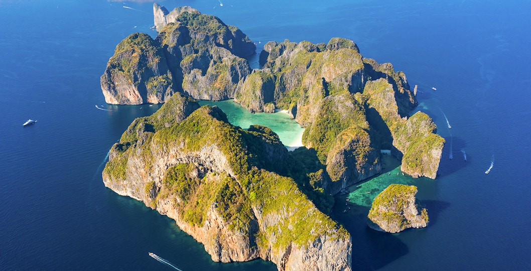 View from above, stunning aerial view of Koh Phi Phi Lee with the beautiful beach of Maya Bay bathed by a turquoise clear water and amazing ridges of limestone