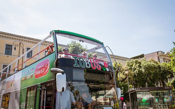 People enjoying Rome Hop-On Hop-Off bus tour on a sunny day.