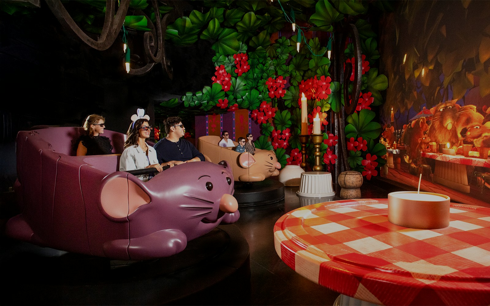 Guests enjoying Ratatouille ride at Walt Disney World Resort, Orlando, surrounded by vibrant decor.