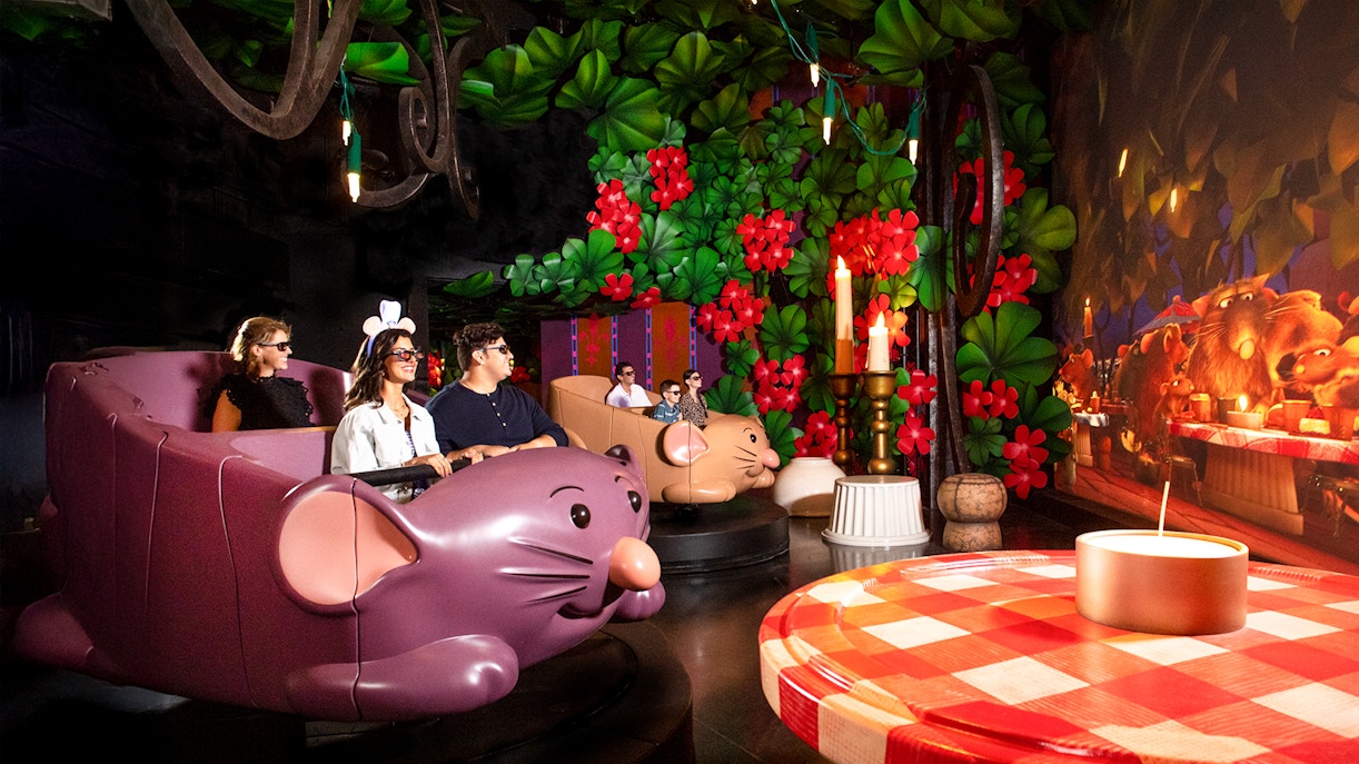 Guests enjoying Ratatouille ride at Walt Disney World Resort, Orlando, surrounded by vibrant decor.