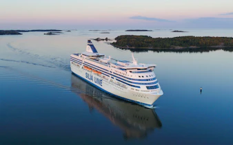 Overnight ferry to Helsinki sailing through calm waters, aerial view.